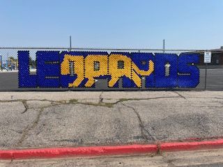 On the fence, in blue and gold, it says leopards.